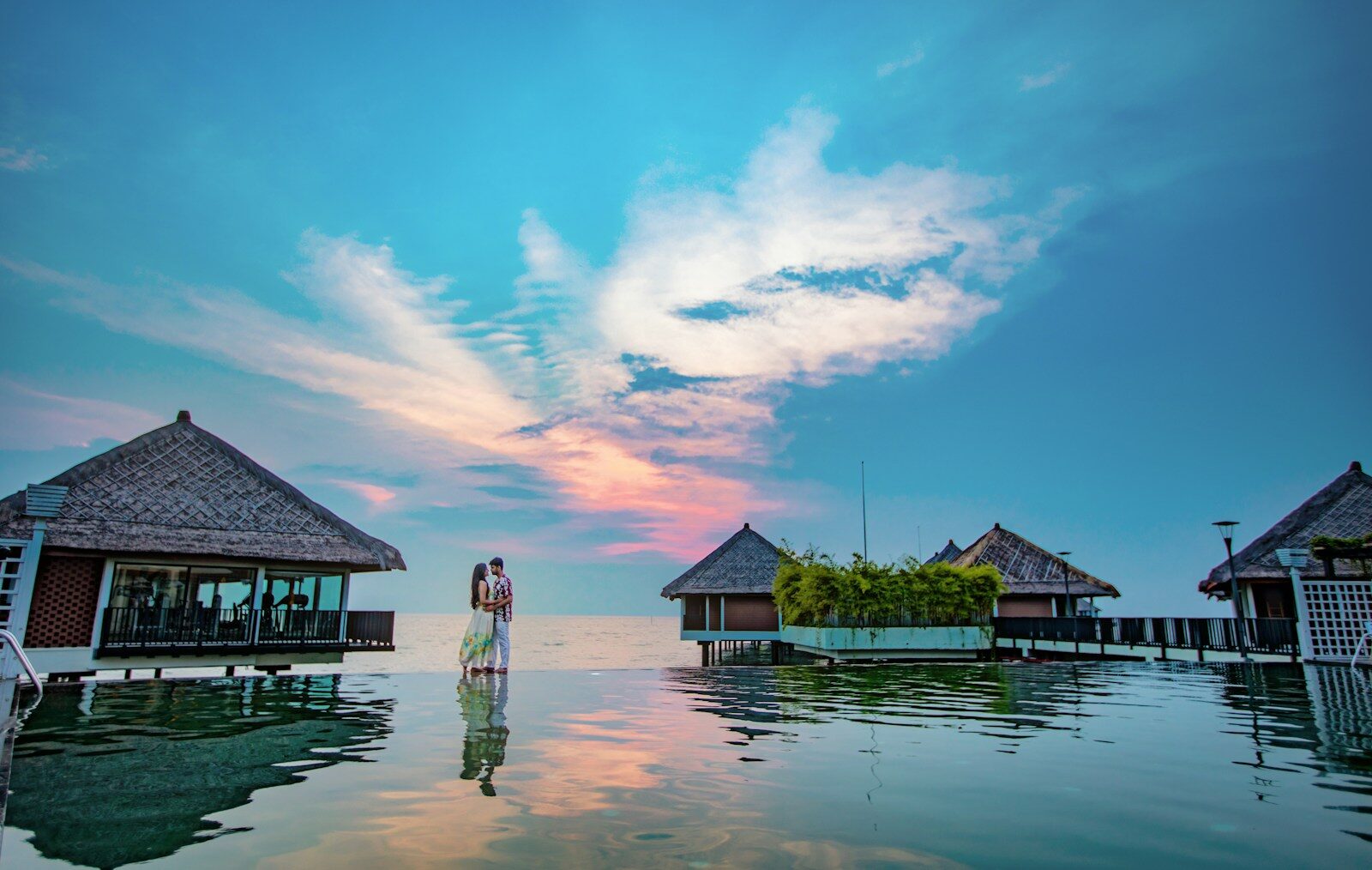 man and woman standing beside beach