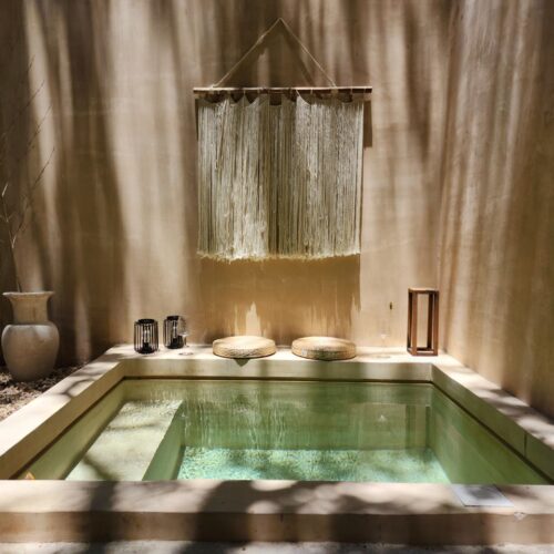 A serene indoor spa setting with natural light and minimalist decor, perfect for relaxation.